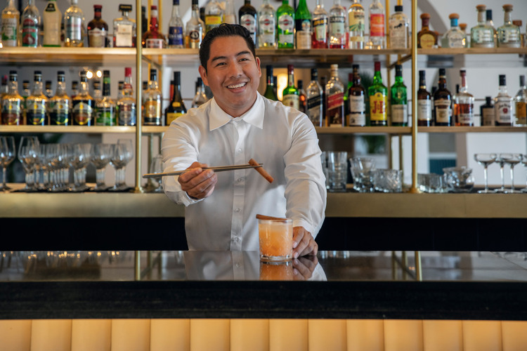 Barman serving a refreshing cocktail in Excellence Riviera Cancun Excellence Club Lounge Bar